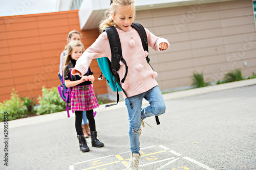 A Hopscotch on the schoolyard with friends play together photo