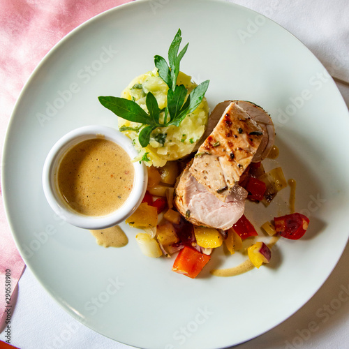 Plate with delicate pork tenderloin with vegetable mash potatoes and sauce photo