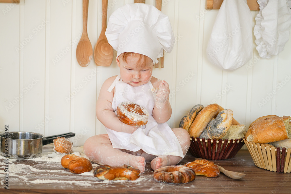 little baker child in chef hat at kitchen table alone little baker child in chef hat at kitchen table alone