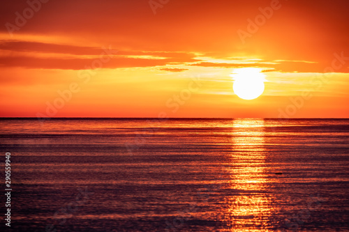 Beautiful red and orange sunset over the sea. The sun goes down over the sea.
