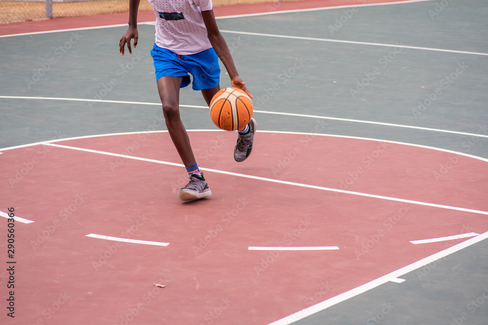 Player dribbling basketball towards the hoop Player dribbling basketball towards the hoop
