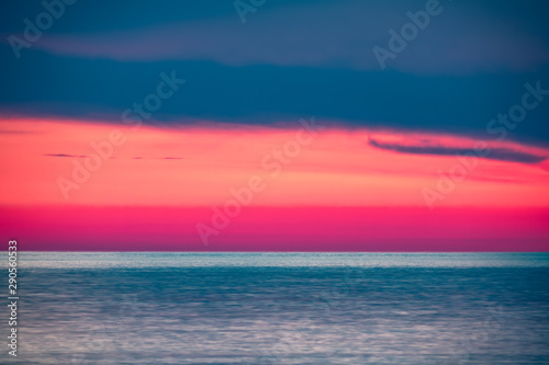 Beautiful pink sunset over the sea. © Dmitrii Potashkin