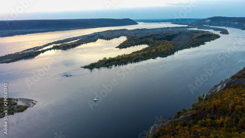 Aerial drone landskape with sunset over Volga river, islands covered with green forest and zhiguli hills at background in Samara, Russia