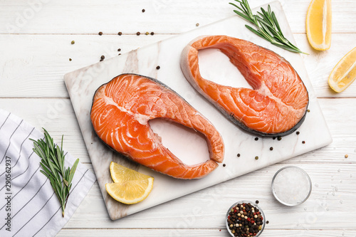 Принти на полотні Flat lay composition with fresh salmon steaks on white wooden table