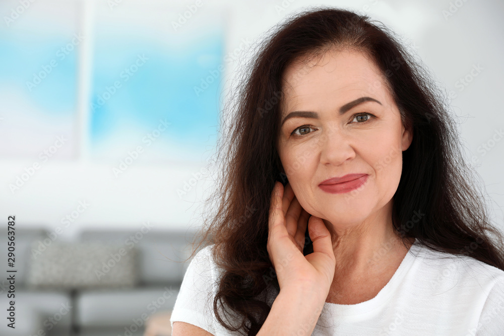 Portrait of mature woman with beautiful face indoors. Space for text