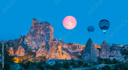 Fototapeta Naklejka Na Ścianę i Meble -  Pigeon Valley with Uchisar castle with moon - Hot air balloon flying over spectacular Cappadocia 