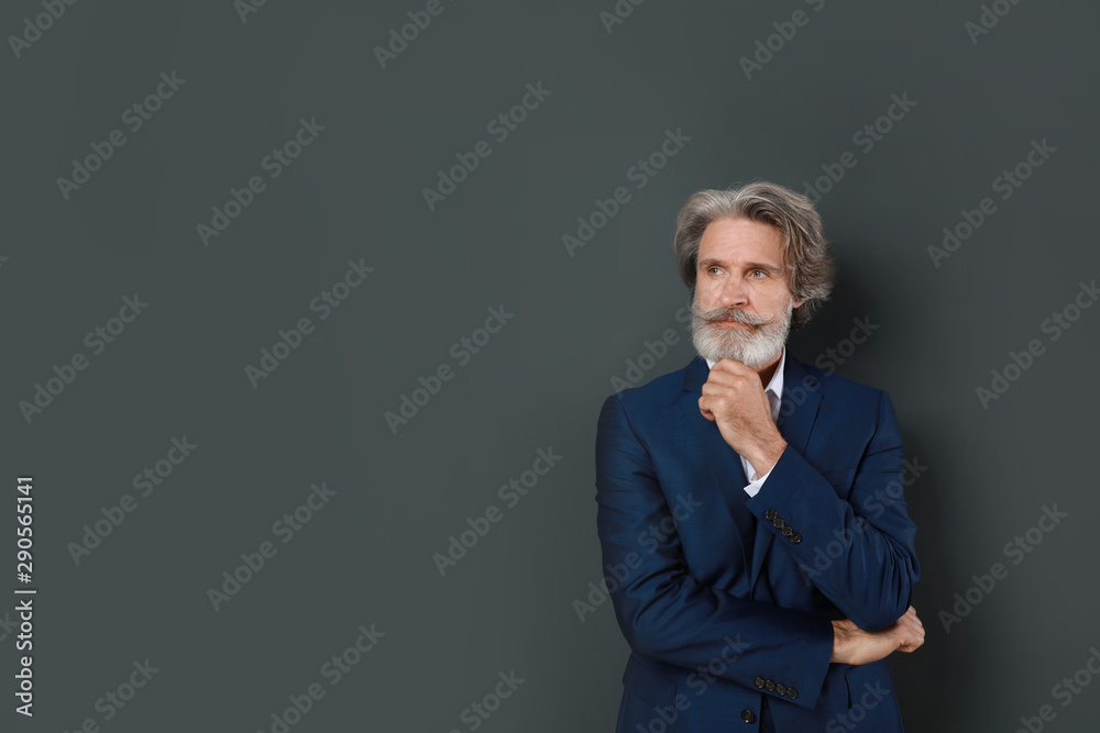 Portrait of handsome mature man on dark background. Space for text Portrait of handsome mature man on dark background. Space for text