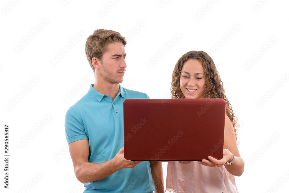 Young Caucasian couple or siblings having fun and laughing with their laptop on white background isolated, boy dressed in blue shirt and girl in pink. Young Caucasian couple or siblings having fun and laughing with their laptop on white background isolated, boy dressed in blue shirt and girl in pink.