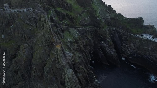 Ruins on Skellig Michael at sunset, tilt up aerial