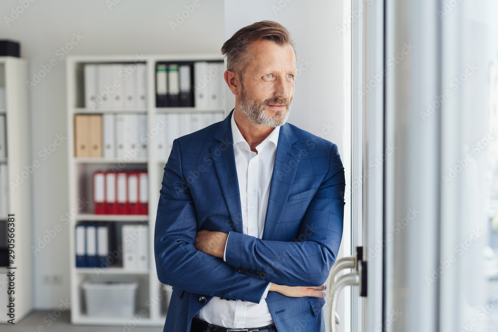 Stylish businessman standing waiting for a client Stylish businessman standing waiting for a client