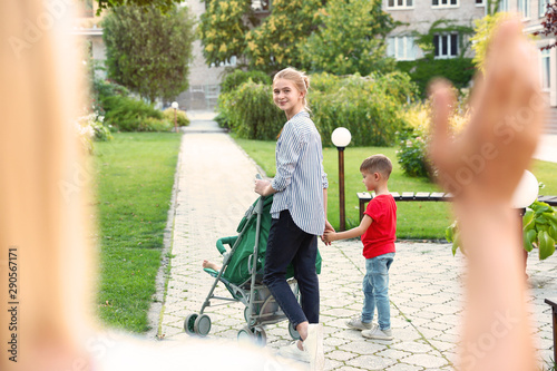 Photography Mother leaving children with teen nanny in park