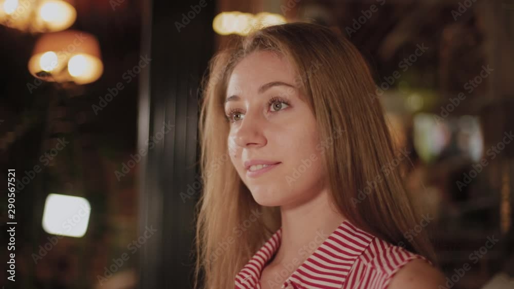 Beautiful girl awaiting her order in an evening cafe. Beautiful girl awaiting her order in an evening cafe.