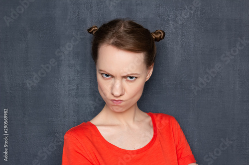 Portrait of funny angry girl looking with displeasure at camera © Andrei Korzhyts