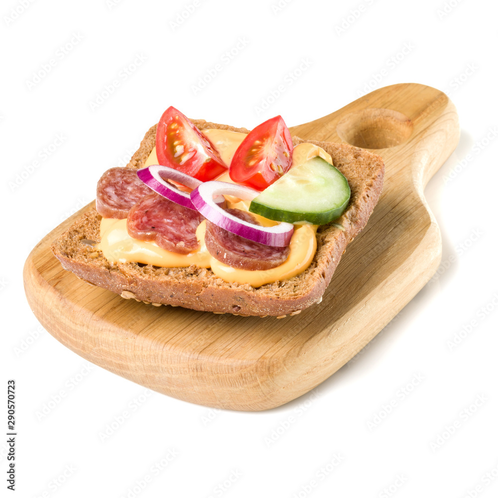 Open faced sausage sandwich canape or crostini on a wooden serving board isolated on white background closeup. Open faced sausage sandwich canape or crostini on a wooden serving board isolated on white background closeup.