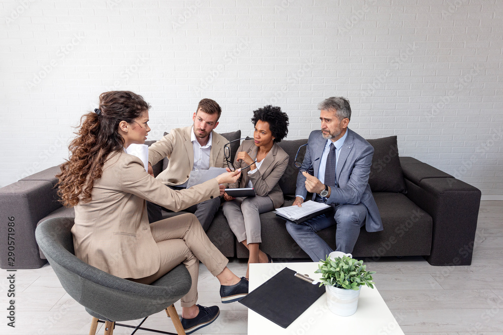 Fototapeta premium Group of four people at office meeting sitting on sofa
