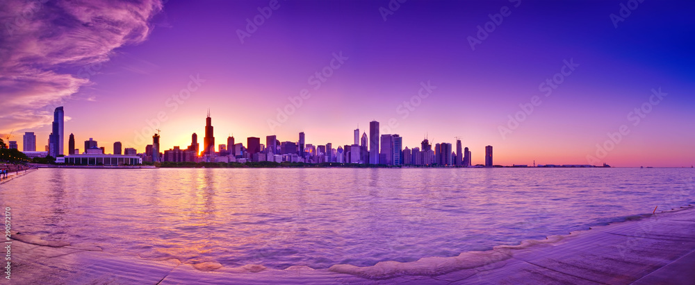 View of Chicago skyline from the shore of Lake Michigan at dusk.