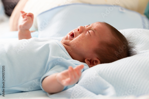 Asian baby newborn crying from diarrhea colic symptoms photo