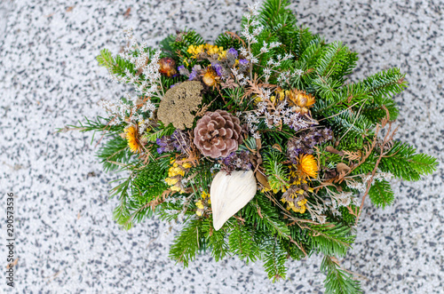 floral decoration on grave during All Saints Day in the cemetery photo