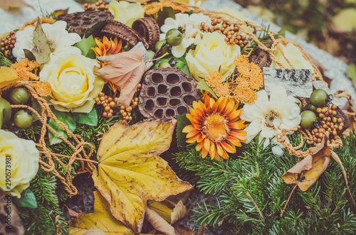 bright floral decoration on grave during All Saints Day in the cemetery photo