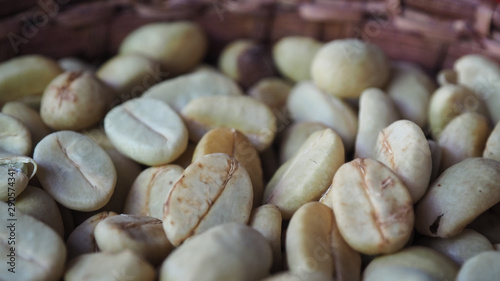 Closeup Shot of Fully or Semi Washed Process Coffee Beans in A Bamboo Basket.  Selective Focus, Blurred Foreground and Background. photo