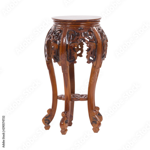 Old antique wooden round table with ornaments and drawer isolated on white
