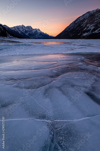 Sunset on a frozen lake in Kananaskis Country in the Canadian Rocky Mountains, Albeta, Canada photo