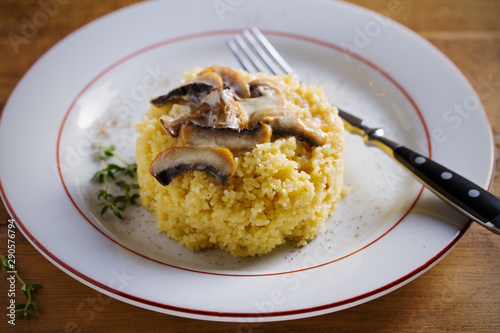 Couscous with mushrooms in cream sauce. Horizontal image