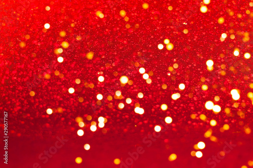 Christmas or New Year decor. Red background with sparkles. Blurred effect