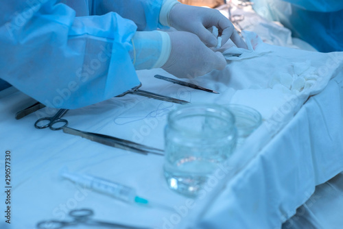hands of a surgeon, nurse, at a sterile table, with medical instruments. Operating room