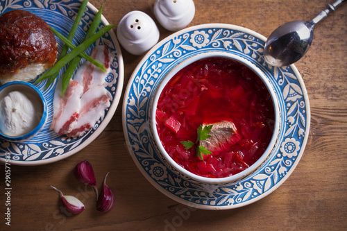 Soup borscht, garlic bun pampushka, sour cream and pork belly. Overhead, horizontal