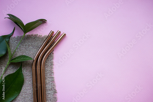 Metal straws on pink background. Zero waste. Flat lay