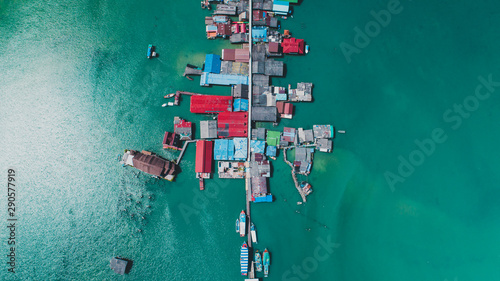 Boats docked beside buildings above water during day photo