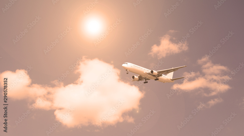 Passenger plane against the sky and white clouds. Evening sunset. Passenger plane against the sky and white clouds. Evening sunset.