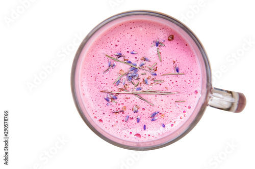 Pink lavender latte coffee in glass mug with flowers, top view