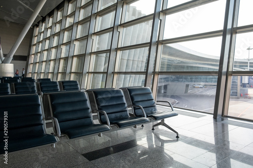 There are empty chairs  benches for passengers waiting for flights at the airport terminal  selected focus