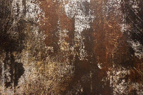 Dark black and brown background texture of a wallpaper with rusty stain and metallic pattern. © Atthapon