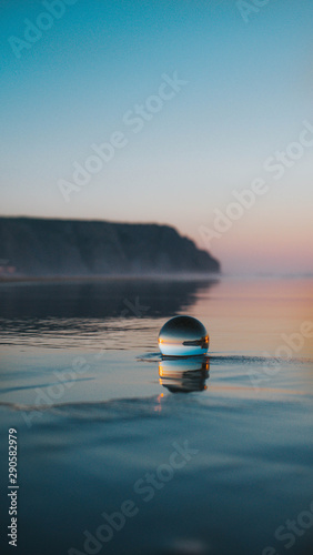 Ball floating on sea photo