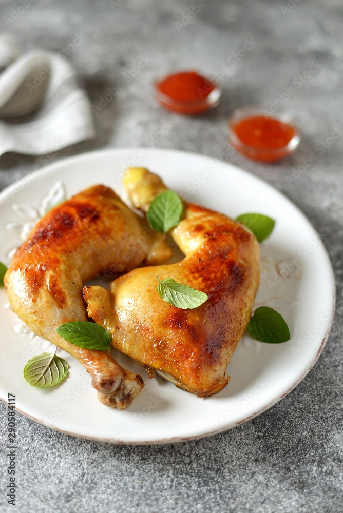 Roasted chicken legs with fresh mint.