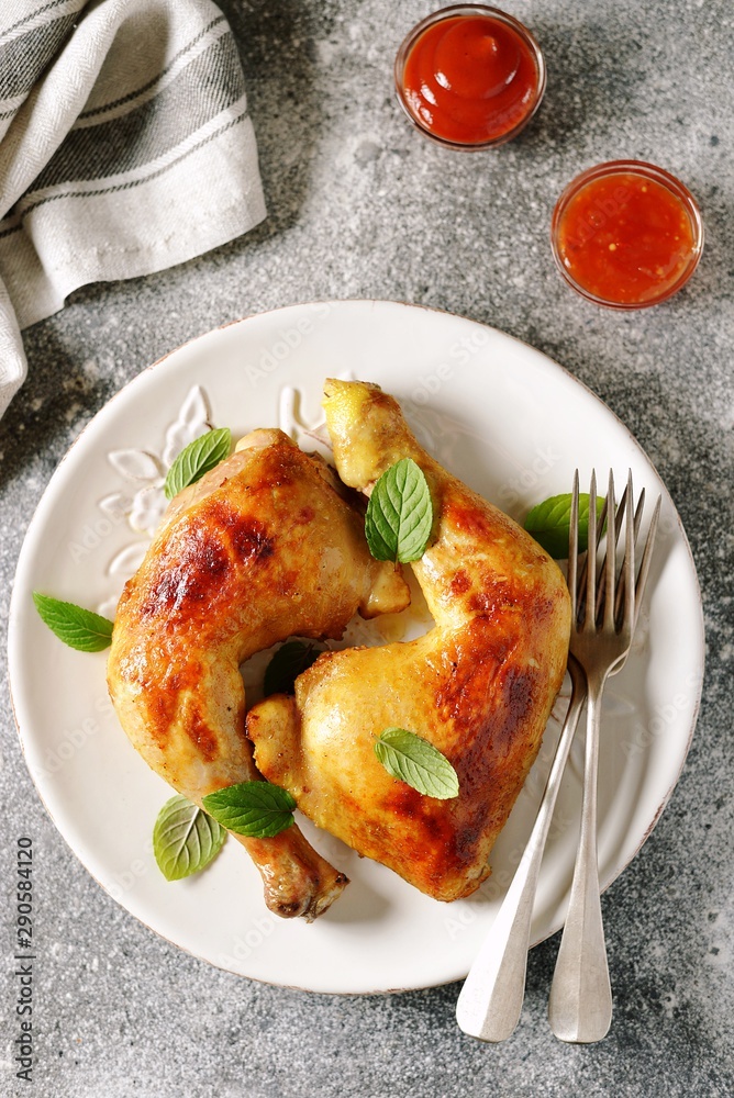 Roasted chicken legs with fresh mint.
