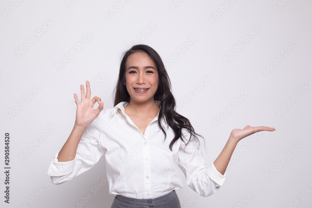 Beautiful young Asian woman show palm hand and OK sign. Beautiful young Asian woman show palm hand and OK sign.