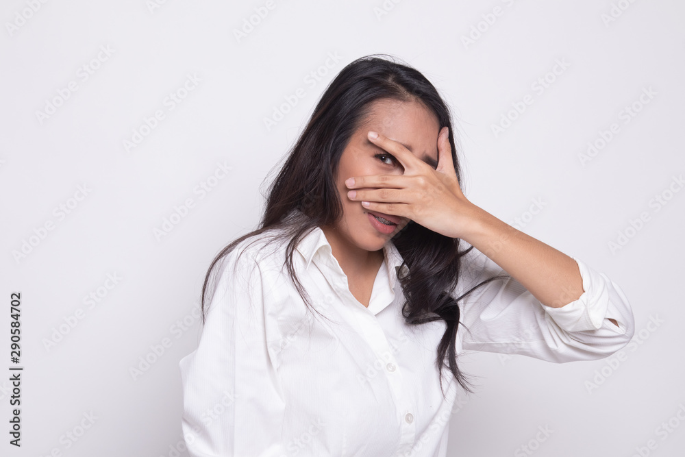 Beautiful young Asian woman peeking through fingers. Beautiful young Asian woman peeking through fingers.