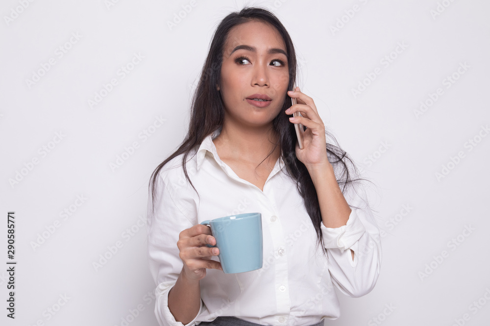 Young Asian woman with mobile phone and coffee cup. Young Asian woman with mobile phone and coffee cup.