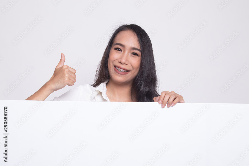 Young Asian woman show thumbs up with blank sign. Young Asian woman show thumbs up with blank sign.