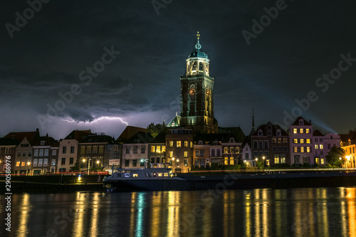 Night image of lightning over a river and historic city of Deventer  the Netherlands
