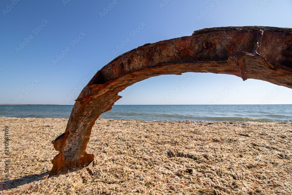 Installation with picturesque colored rusty iron on the beach. Krapets, the Black Sea coast, Bulgaria.