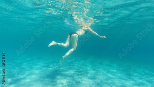 Underwater photo of woman swimming in tropical exotic bay with crystal clear sea © aerial-drone