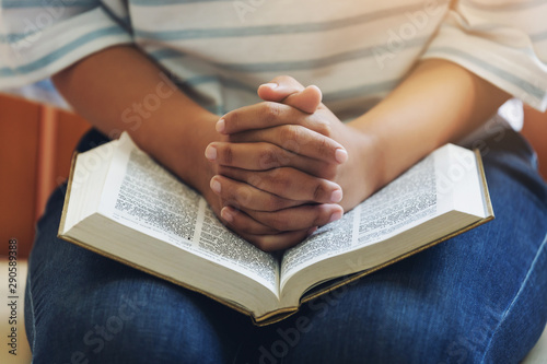 Φωτογραφία A Girl hand praying with holy bible