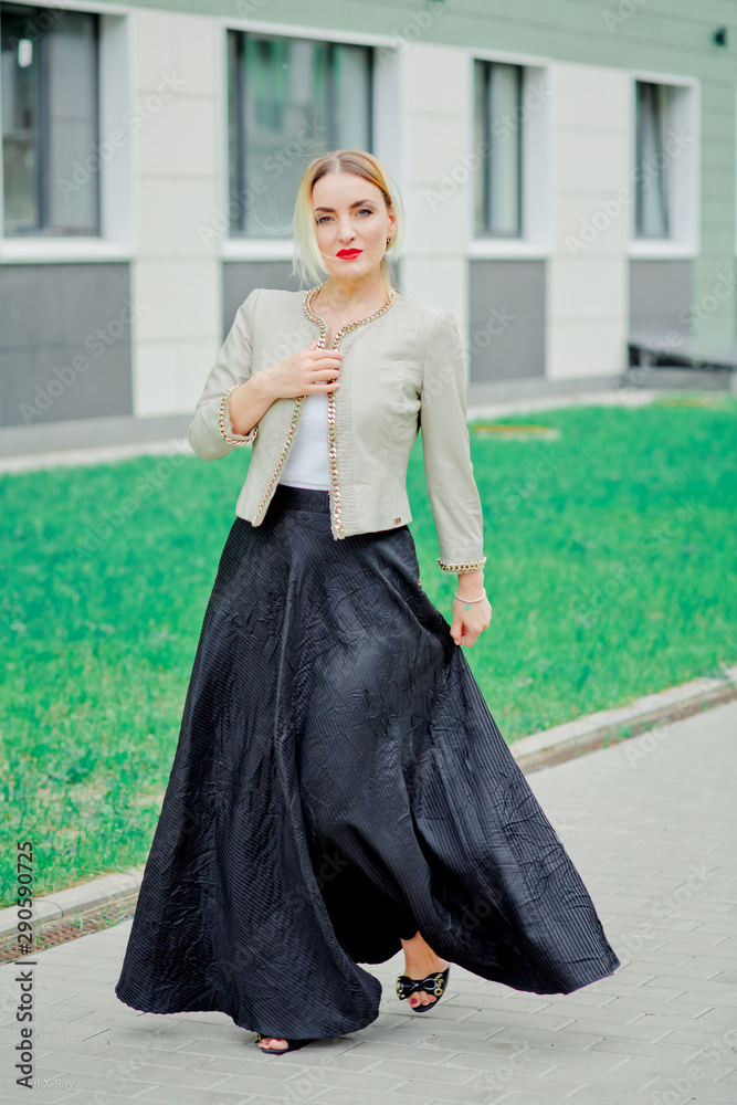 Stylish fashion portrait of blonde woman. Posing in the city