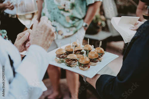 Man serves burger sliders