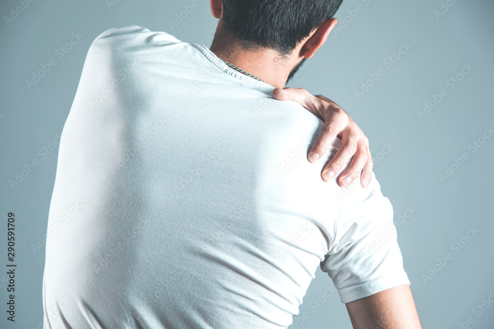 man hand in ache back man hand in ache back